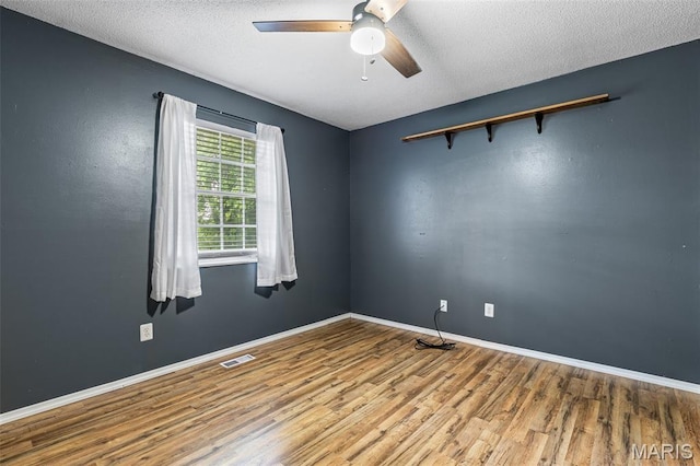 1 Mileva Ct, Farmington, MO 63640 - empty room featuring wood finished floors, a ceiling fan, baseboards, and a textured ceiling