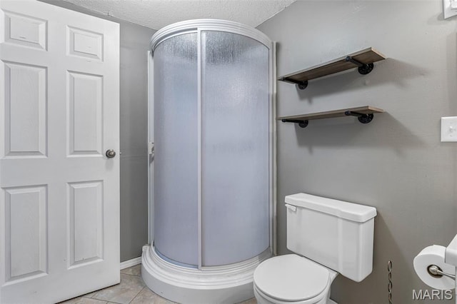 1 Mileva Ct, Farmington, MO 63640 - bathroom with a stall shower, toilet, a textured ceiling, and tile patterned flooring