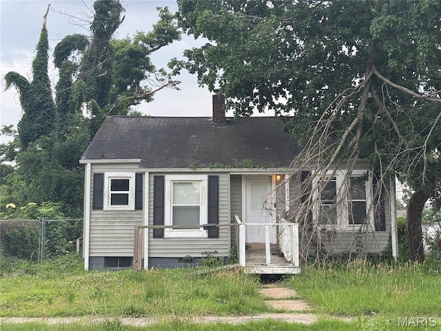 319 Benton St, Sikeston, MO 63801 - view of front of home with a chimney and a shingled roof