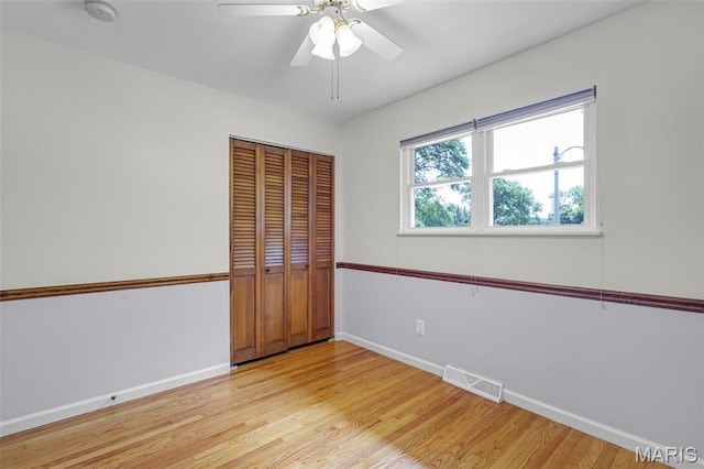 1385 Mallard Ln, Florissant, MO 63031 - unfurnished bedroom featuring light wood-style floors, a closet, and a ceiling fan
