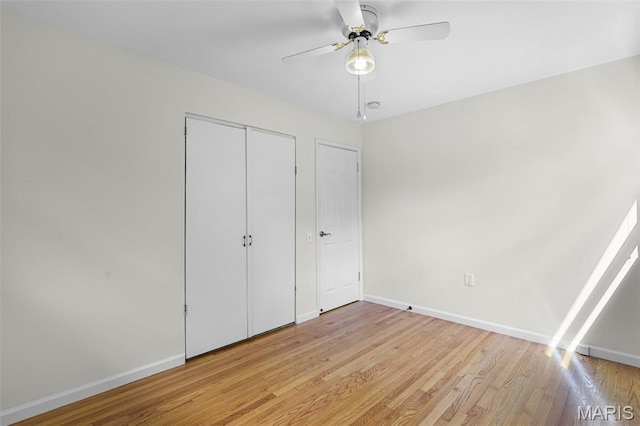 1385 Mallard Ln, Florissant, MO 63031 - unfurnished bedroom with light wood-type flooring, a closet, and a ceiling fan