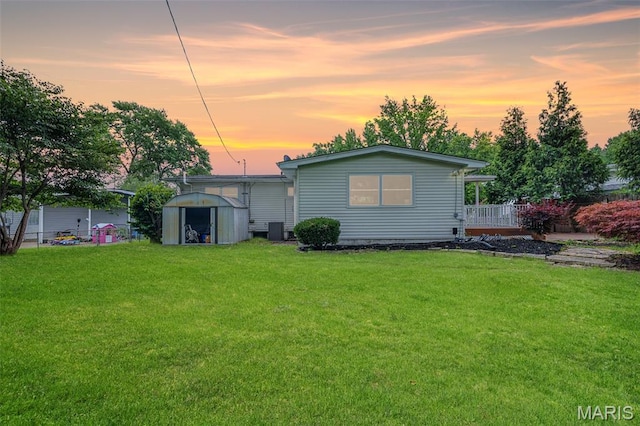 1385 Mallard Ln, Florissant, MO 63031 - rear view of house with a storage unit and a yard