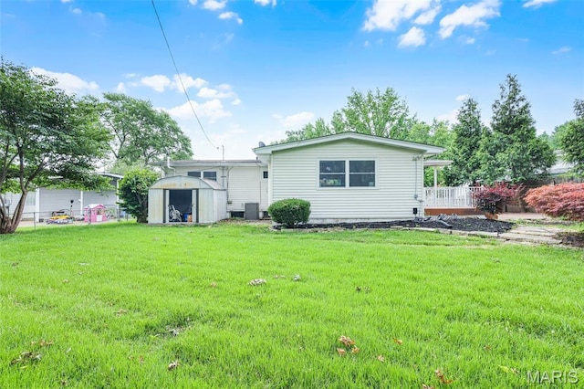 1385 Mallard Ln, Florissant, MO 63031 - rear view of house featuring a storage unit and a lawn