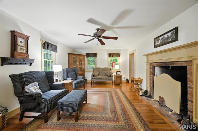 1423 Emily Ln, Festus, MO 63028 - living area with wood finished floors, ceiling fan, and a fireplace