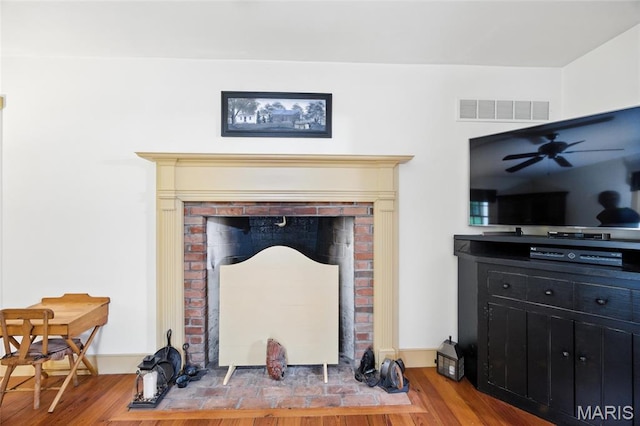 1423 Emily Ln, Festus, MO 63028 - detailed view of wood finished floors, a ceiling fan, and a brick fireplace