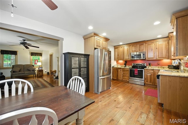 1423 Emily Ln, Festus, MO 63028 - kitchen with stainless steel appliances, a ceiling fan, light wood-style flooring, recessed lighting, and open floor plan