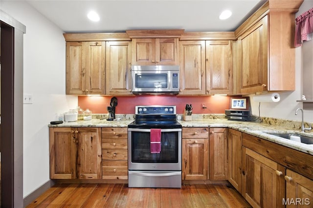 1423 Emily Ln, Festus, MO 63028 - kitchen with stainless steel appliances, light wood-style floors, light stone countertops, and recessed lighting