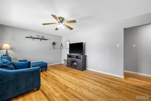 12006 Glengrove Dr, Maryland Heights, MO 63043 - living room with light wood-style flooring, ceiling fan, and a fireplace