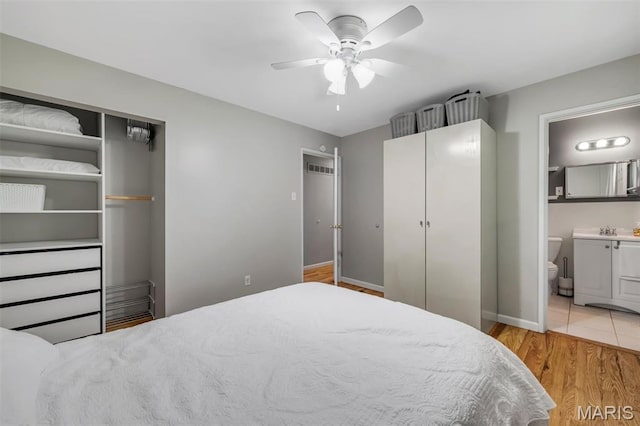 12006 Glengrove Dr, Maryland Heights, MO 63043 - bedroom with light wood-style flooring, connected bathroom, and a ceiling fan