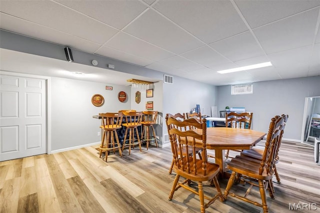 12006 Glengrove Dr, Maryland Heights, MO 63043 - dining room with a bar, a drop ceiling, and wood finished floors