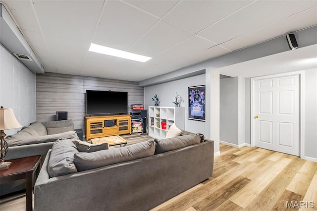 12006 Glengrove Dr, Maryland Heights, MO 63043 - living room with an accent wall, light wood finished floors, and wood walls