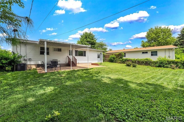 12006 Glengrove Dr, Maryland Heights, MO 63043 - rear view of house with entry steps, a lawn, and a patio