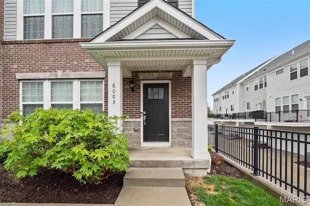 8003 Townes Way, Saint Louis, MO 63117 - property entrance with brick siding and a chimney