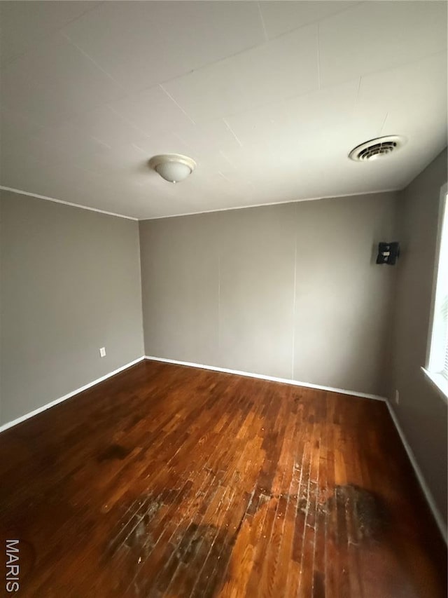 711 E Gladys St, Sikeston, MO 63801 - empty room featuring hardwood / wood-style flooring and baseboards
