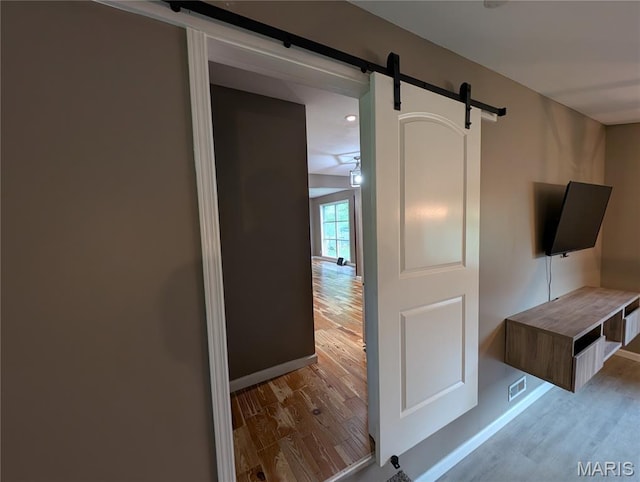 326 S Elm St, Bethalto, IL 62010 - interior space featuring a barn door, wood finished floors, and baseboards