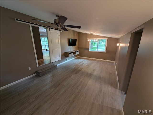326 S Elm St, Bethalto, IL 62010 - unfurnished living room with vaulted ceiling, wood finished floors, baseboards, and ceiling fan
