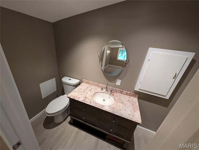 326 S Elm St, Bethalto, IL 62010 - half bath with wood finished floors, vanity, toilet, and baseboards
