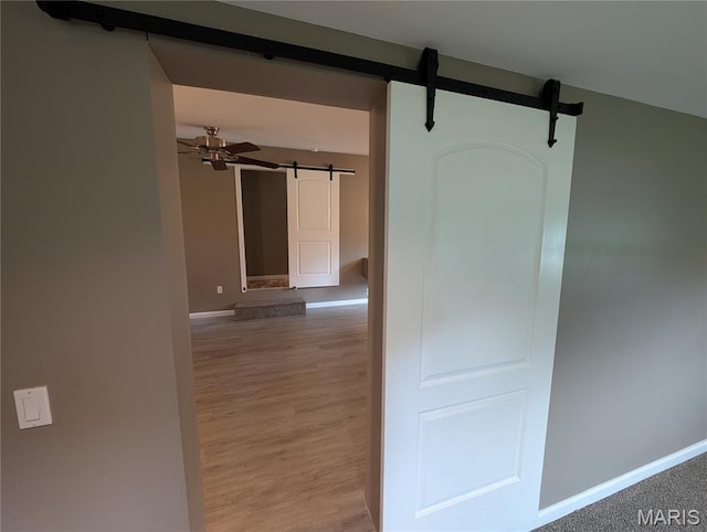 326 S Elm St, Bethalto, IL 62010 - corridor with a barn door, baseboards, and light wood finished floors
