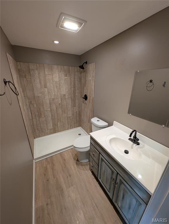 326 S Elm St, Bethalto, IL 62010 - bathroom featuring vanity, toilet, tiled shower, and wood finished floors