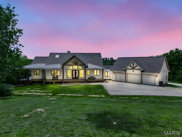 22206 Tree Farm Rd, Hermann, MO 63383 - modern farmhouse with a standing seam roof, driveway, a yard, and covered porch