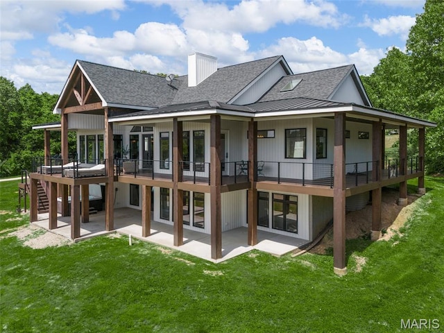 22206 Tree Farm Rd, Hermann, MO 63383 - back of house with roof with shingles, a patio area, and a lawn