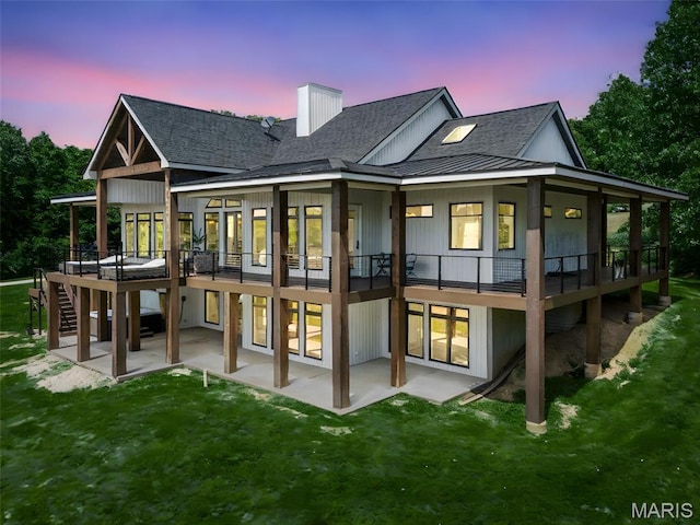22206 Tree Farm Rd, Hermann, MO 63383 - back of house with a patio area, a yard, and a shingled roof