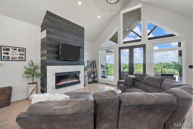 22206 Tree Farm Rd, Hermann, MO 63383 - living room featuring a fireplace, french doors, wood finished floors, baseboards, and high vaulted ceiling