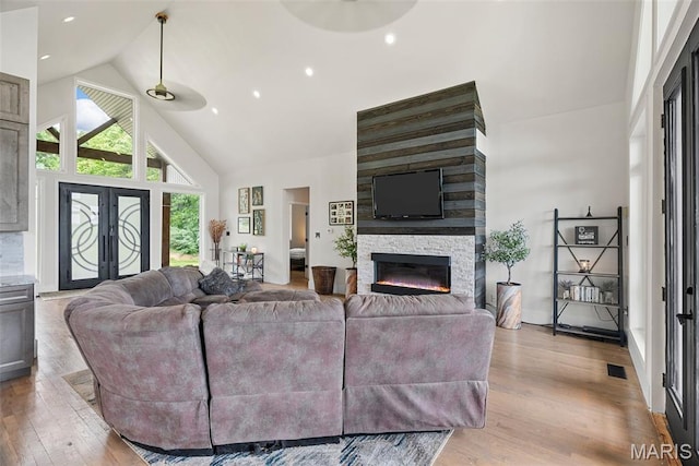 22206 Tree Farm Rd, Hermann, MO 63383 - living room featuring light wood-style floors, high vaulted ceiling, and a fireplace