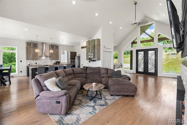 22206 Tree Farm Rd, Hermann, MO 63383 - living area featuring light wood-type flooring, high vaulted ceiling, and recessed lighting