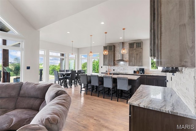 22206 Tree Farm Rd, Hermann, MO 63383 - kitchen with open floor plan, wall chimney range hood, plenty of natural light, and recessed lighting