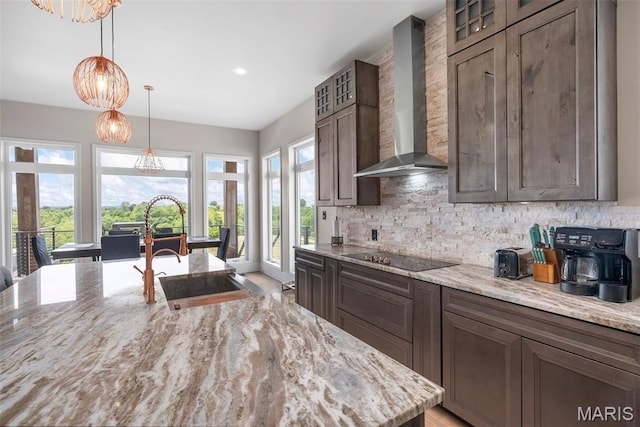 22206 Tree Farm Rd, Hermann, MO 63383 - kitchen featuring wall chimney exhaust hood, black electric cooktop, backsplash, light stone counters, and recessed lighting