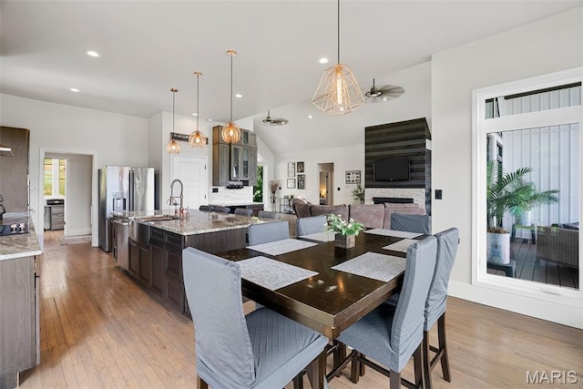 22206 Tree Farm Rd, Hermann, MO 63383 - dining room featuring light wood-style floors, vaulted ceiling, ceiling fan, and recessed lighting