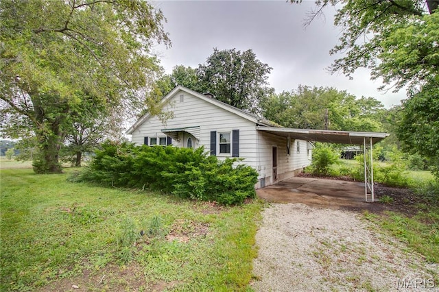 33974 Irish Ln, Brighton, IL 62012 - ranch-style home featuring driveway, a carport, and a front lawn