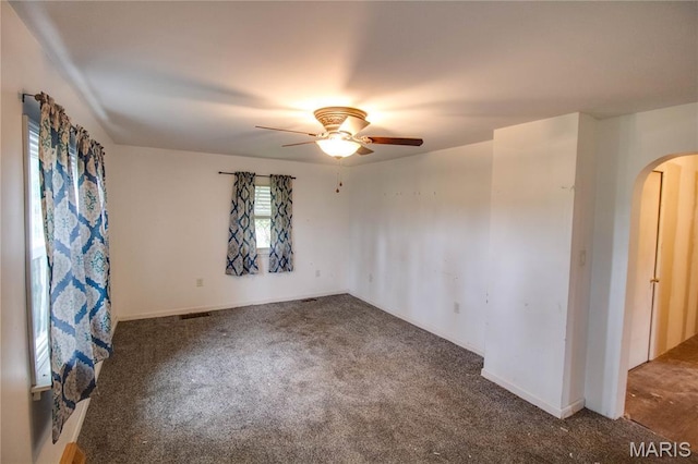 33974 Irish Ln, Brighton, IL 62012 - carpeted spare room with arched walkways and ceiling fan
