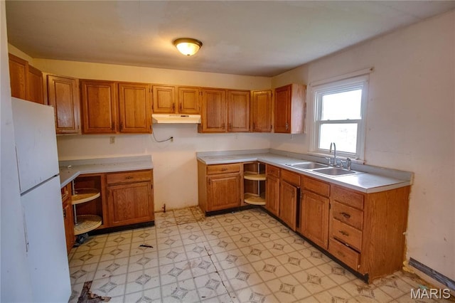 33974 Irish Ln, Brighton, IL 62012 - kitchen featuring freestanding refrigerator, light flooring, under cabinet range hood, and brown cabinets