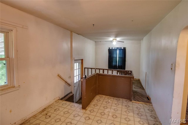 33974 Irish Ln, Brighton, IL 62012 - spare room featuring light floors, arched walkways, and a ceiling fan