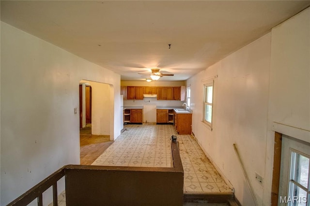 33974 Irish Ln, Brighton, IL 62012 - kitchen with light floors, brown cabinets, a ceiling fan, light countertops, and under cabinet range hood