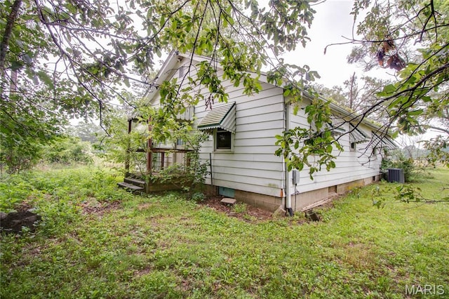 33974 Irish Ln, Brighton, IL 62012 - view of home's exterior with a lawn and a central AC unit
