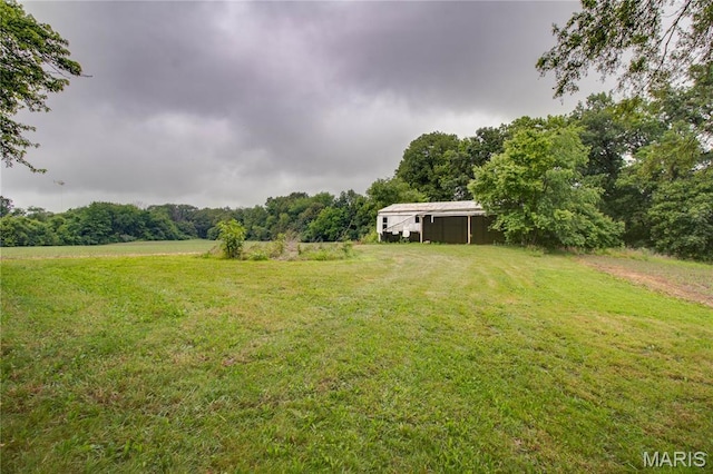 33974 Irish Ln, Brighton, IL 62012 - view of green lawn featuring a wooded view and an outdoor structure