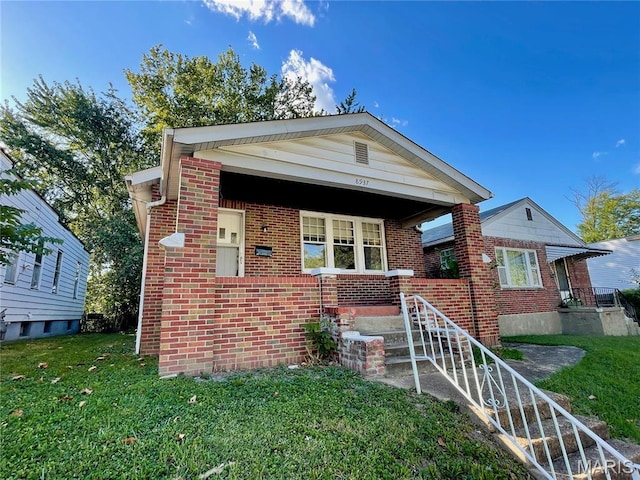 8937 Edna St, Saint Louis, MO 63147 - bungalow-style house featuring brick siding and a front lawn