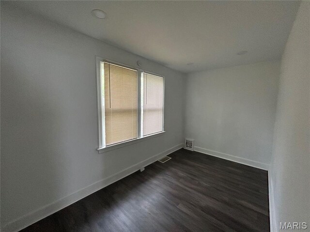 8937 Edna St, Saint Louis, MO 63147 - empty room featuring dark wood finished floors and baseboards
