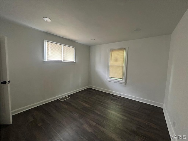 8937 Edna St, Saint Louis, MO 63147 - empty room with dark wood-style flooring, baseboards, and recessed lighting