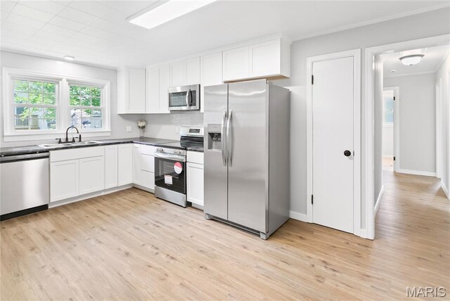 420 E Hauser St, Litchfield, IL 62056 - kitchen featuring appliances with stainless steel finishes, light wood-style floors, white cabinetry, a sink, and crown molding