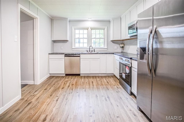 420 E Hauser St, Litchfield, IL 62056 - kitchen with stainless steel appliances, a sink, light wood finished floors, and white cabinets