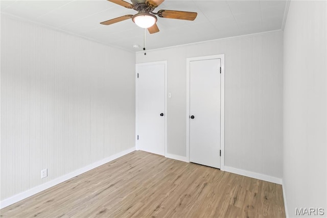 420 E Hauser St, Litchfield, IL 62056 - unfurnished bedroom featuring wood finished floors, baseboards, crown molding, and a ceiling fan