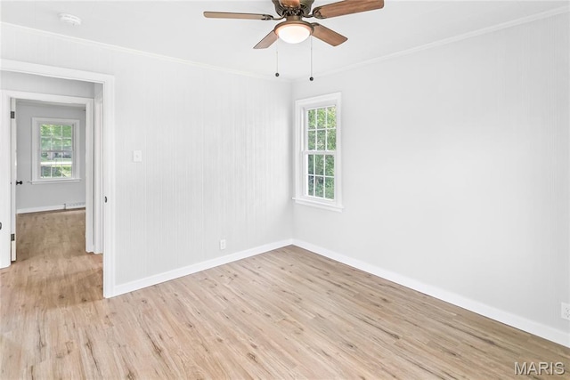 420 E Hauser St, Litchfield, IL 62056 - spare room with crown molding, baseboards, light wood-style floors, and ceiling fan