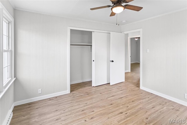 420 E Hauser St, Litchfield, IL 62056 - unfurnished bedroom with a baseboard heating unit, wood finished floors, crown molding, a closet, and baseboards