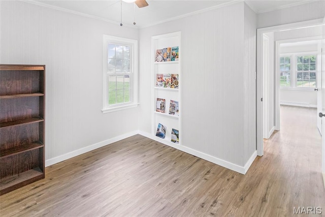 420 E Hauser St, Litchfield, IL 62056 - spare room featuring crown molding, wood finished floors, ceiling fan, and baseboards