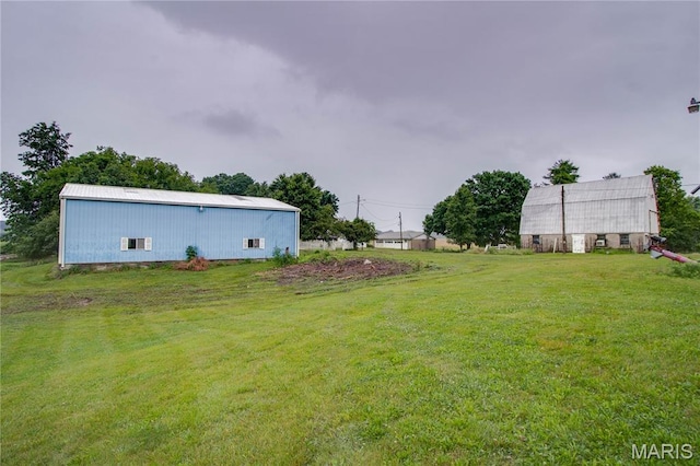 33425 Irish Ln, Brighton, IL 62012 - view of green lawn featuring a pole building and an outdoor structure
