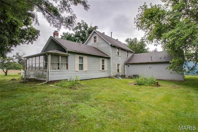33425 Irish Ln, Brighton, IL 62012 - rear view of property with a chimney, a yard, and a sunroom